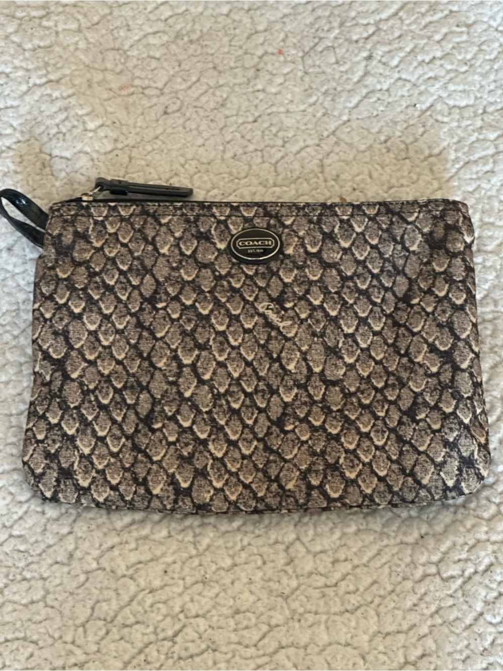 Coach Black and White Signature snake pattern pouch.